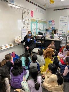 SCU Coordinator reading to students